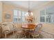 Bright breakfast nook features a round table, bench seating, and window shutters at 461 Troy Loop, The Villages, FL 32162