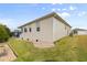 Tan house with landscaped yard and partial view of a neighboring home at 461 Troy Loop, The Villages, FL 32162