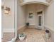 Inviting front entry with a tiled walkway and potted plants at 461 Troy Loop, The Villages, FL 32162