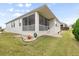 Single-story home with screened porch and landscaped yard at 461 Troy Loop, The Villages, FL 32162