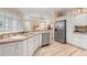 Modern kitchen featuring white cabinetry and ample counter space at 461 Troy Loop, The Villages, FL 32162