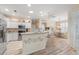 Kitchen boasts a breakfast bar, white cabinets, and stainless steel appliances at 461 Troy Loop, The Villages, FL 32162