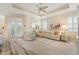 Living room features a large sectional sofa, stone accent wall, and plenty of natural light at 461 Troy Loop, The Villages, FL 32162