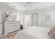 Main bedroom with large dresser, and en-suite bathroom at 461 Troy Loop, The Villages, FL 32162