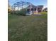 Large backyard with grassy area and screened pool at 4635 Deer Run Rd, St Cloud, FL 34772