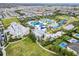 Aerial view of community water park with pools, slides, and lounging areas surrounded by lush landscaping at 220 Clawson Way, Kissimmee, FL 34747