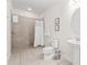 Clean, accessible bathroom with a tiled walk-in shower and pedestal sink at 220 Clawson Way, Kissimmee, FL 34747