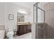 Spacious bathroom with a glass-enclosed shower, dark wood vanity with double sinks at 220 Clawson Way, Kissimmee, FL 34747