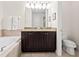Bathroom featuring a double vanity, tub, and toilet at 220 Clawson Way, Kissimmee, FL 34747