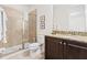Bathroom featuring granite counters, dark cabinets, and glass enclosed shower at 220 Clawson Way, Kissimmee, FL 34747