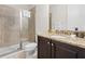 Bathroom featuring granite counters, dark cabinets, and glass enclosed shower at 220 Clawson Way, Kissimmee, FL 34747