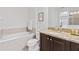 Elegant bathroom with a garden tub, granite counters, and dark wood cabinets at 220 Clawson Way, Kissimmee, FL 34747