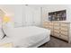 Bedroom featuring white bedding, a dresser, and mounted television at 220 Clawson Way, Kissimmee, FL 34747
