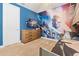 Bedroom with Star Wars themed wall mural, TV, and wood dresser at 220 Clawson Way, Kissimmee, FL 34747