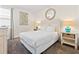 Cozy bedroom with a white bed, lamps, and beach themed decor at 220 Clawson Way, Kissimmee, FL 34747
