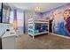 Charming bedroom featuring a themed bunk bed, chandelier, and a vibrant, decorative wall mural at 220 Clawson Way, Kissimmee, FL 34747
