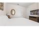 Well-lit bedroom featuring a queen bed, TV, and a glimpse of the outdoor scenery at 220 Clawson Way, Kissimmee, FL 34747