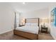 Neutral bedroom with a king bed, lamps, side tables, and soft carpet at 220 Clawson Way, Kissimmee, FL 34747