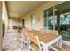 Relax in this covered patio with an outdoor dining set next to the sliding glass door at 220 Clawson Way, Kissimmee, FL 34747