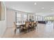 Spacious dining room with a large table and access to an outdoor seating area through sliding glass doors at 220 Clawson Way, Kissimmee, FL 34747