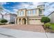 Charming two-story home featuring an arched entryway, a two-car garage, and a brick paver driveway at 220 Clawson Way, Kissimmee, FL 34747