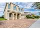 Charming two-story home featuring an arched entryway, a two-car garage, and a brick paver driveway at 220 Clawson Way, Kissimmee, FL 34747