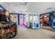 An exciting game room featuring various arcade games and prize machines for Gathering fun at 220 Clawson Way, Kissimmee, FL 34747