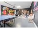 Finished game room with an arcade, a ping pong table and Pac-Personal themed artwork at 220 Clawson Way, Kissimmee, FL 34747