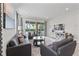 Comfortable living room with a glass sliding door leading to an outdoor patio and pool area at 220 Clawson Way, Kissimmee, FL 34747