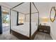 Elegant main bedroom featuring a four-poster bed, carpet, and outdoor access at 220 Clawson Way, Kissimmee, FL 34747
