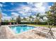 Pool with attached spa, outdoor furniture, and beautiful Florida landscaping at 220 Clawson Way, Kissimmee, FL 34747