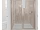 Modern bathroom shower stall featuring glass doors and neutral tile walls at 220 Clawson Way, Kissimmee, FL 34747