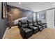 Home theater room with large reclining seats, dark walls, and plush carpeting at 220 Clawson Way, Kissimmee, FL 34747