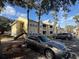 Condo building with parking spaces and palm trees at 1031 S Hiawassee Rd # 2524, Orlando, FL 32835