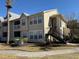 Two-story tan condo building with palm trees and stairs at 1049 S Hiawassee Rd # 3412, Orlando, FL 32835