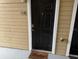 Apartment entry with black door and welcome mat at 1065 S Hiawassee Rd # 1416, Orlando, FL 32835