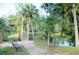 Brick pathway and footbridge over a pond at 255 Crown Oaks Way, Longwood, FL 32779