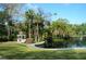 White gazebo near a lake with tropical plants at 255 Crown Oaks Way, Longwood, FL 32779