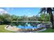 Serene lake view with lush landscaping and palm trees at 255 Crown Oaks Way, Longwood, FL 32779