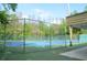 Two tennis courts surrounded by a chain link fence at 255 Crown Oaks Way, Longwood, FL 32779