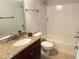 Clean bathroom with granite countertop vanity and tiled tub/shower at 5124 Conroy Rd # 27, Orlando, FL 32811