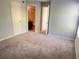 Carpeted bedroom with access to bathroom and hallway at 5124 Conroy Rd # 27, Orlando, FL 32811