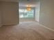 Spacious bedroom with large window and plush carpeting at 5124 Conroy Rd # 27, Orlando, FL 32811