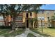 Two-story condo building with tan exterior and lush landscaping at 5124 Conroy Rd # 27, Orlando, FL 32811