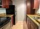 Efficient galley kitchen, granite countertops, and dark wood cabinets at 5124 Conroy Rd # 27, Orlando, FL 32811