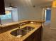 Modern kitchen with granite countertops and stainless steel appliances at 5124 Conroy Rd # 27, Orlando, FL 32811