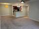 Living room with carpeting, light walls, and kitchen bar at 5124 Conroy Rd # 27, Orlando, FL 32811