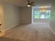 Bright living room with large window and ceiling fan at 5124 Conroy Rd # 27, Orlando, FL 32811