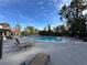 Community swimming pool with lounge chairs and surrounding trees at 5124 Conroy Rd # 27, Orlando, FL 32811