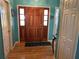 Bright entryway with hardwood floors and a wooden door at 305 Pinecrest Rd, Mount Dora, FL 32757